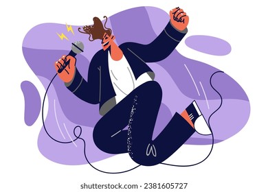 Man singer with microphone in hands jumps up speaking to audience on stage and enjoys singing. Young energetic guy singer performs favorite songs in karaoke and enjoys creative hobby