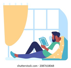 Man siting on floor with book. Home reading concept