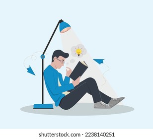 hombre sentado en el suelo y estudiando el libro 