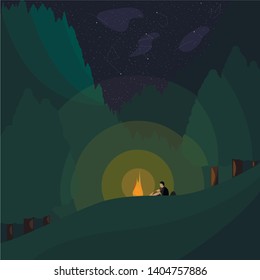 A man sits by the fire in the forest at night. View of the stars and the reflection of the moon on the wooded mountains.