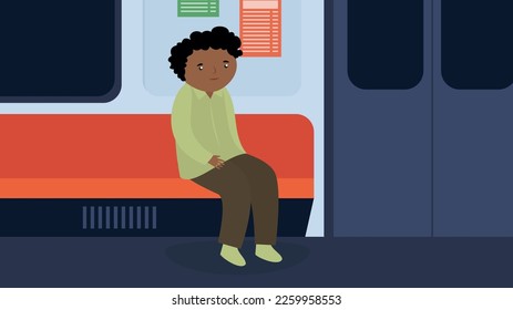 A man sits by himself on a seat in the subway
