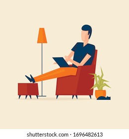Man sits in a chair at home with a laptop, work from home, self-isolation, freelance.