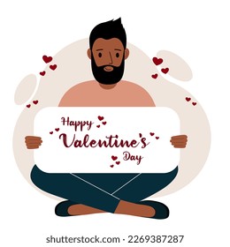 A man sits cross-legged and holds a large card with a congratulation for saint valentine. Vector flat illustration