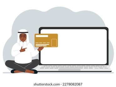 A man sits cross-legged and holds a large plastic card. Next to the man is a large laptop with space for text. Vector flat illustration
