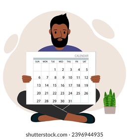 A man sits cross-legged and holds a large calendar glider in his hands. Concept of planning, make plans, schedule, event.