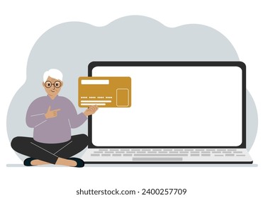 A man sits cross-legged and holds a large plastic card. Next to the man is a large laptop with space for text.