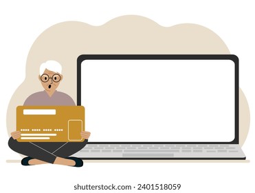 A man sits cross-legged and holds a large plastic card. Next to the man is a large laptop with space for text.