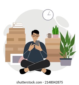 A man sits cross-legged with a mobile phone, orders delivery, there are many things around in cardboard boxes. The man is preparing to move to another home. Vector flat illustration.