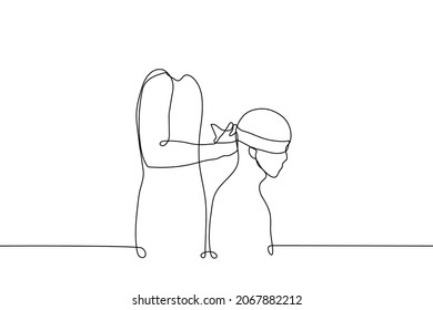 man sits him someone from the back blindfolds with wide ribbon - one line drawing vector. concept of playing blind man's buff;