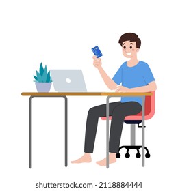 A man sits at his desk and holding a credit card to purchase shopping online on internet store from remote place. New normal trading trend of buy and sale on network.