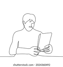 man sits holding a tablet in which he looks with both hands - one line drawing. concept of online surfing, buying a new gadget (tablet) 