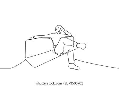 man sits on a sofa with his hand over the back and the other props his head with his leg over his leg - one line drawing vector. concept of free time, procrastination, rest, idleness, laziness