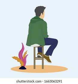 Ein Mann sitzt allein auf einem Stuhl