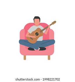 Man sitting in armchair making music with guitar