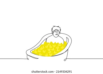 man sitting in bathtub filled with yellow rubber ducks - one line drawing vector. concept adult man sad in bathtub full of toy ducks