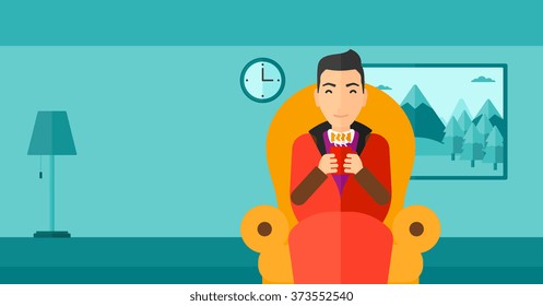 Hombre sentado en una silla con una taza de té.