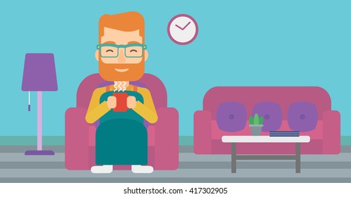 Man sitting in chair with cup of tea.