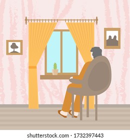 A man sitting in a comfortable chair looks out the window.