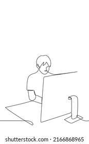 man sitting at the computer - one line drawing vector. concept work from home, freelancer, coworking, workplace, huge monitor