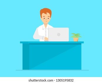 A man is sitting at the computer at the workplace, a laptop, a table, a houseplant