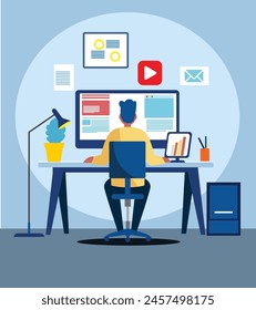 A man is sitting at a desk with a computer monitor and a keyboard