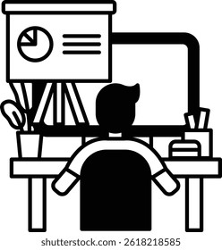 A man is sitting at a desk with a computer monitor and a presentation board