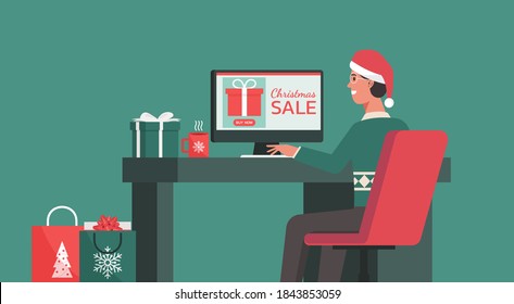 Hombre sentado en el escritorio y haciendo el pedido en una pantalla de computadora en su oficina en las vacaciones de Navidad, concepto de compras en línea o venta de invierno, ilustración vectorial plana
