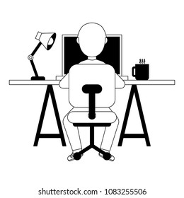man sitting at the desk and working on the computer pencils back view