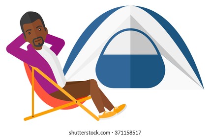 Man sitting in folding chair.