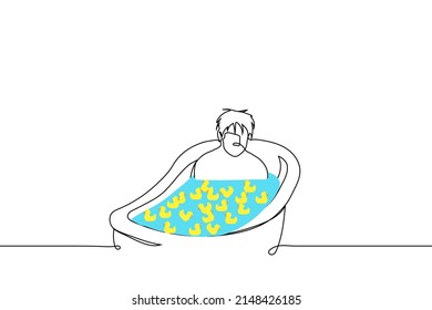 man is sitting in full bath and yellow rubber ducks are floating there - one line drawing vector. concept sad adult man taking a bath nostalgic for childhood