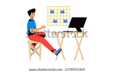 A man is sitting at his desk. A man in the workplace, a computer desk at home. The concept of remote work, training, self-education