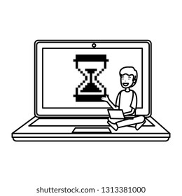 man sitting in laptop with hourglass