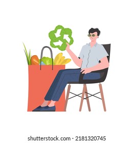 A man is sitting next to a bag of healthy food and is holding an EKO icon. Isolated. Trend style, vector illustration.