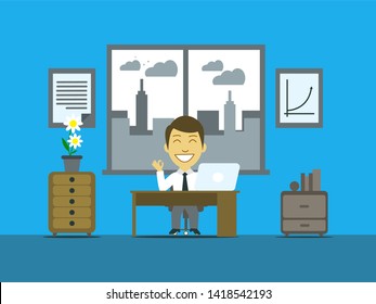 A man sitting in a office, the town view is at his back.