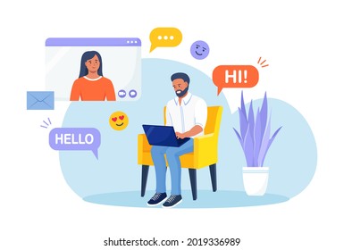 Man is sitting on armchair and using laptop for video call with girl friend or colleague. Friends talking online. Online education and e-learning. Social media or Dating app and virtual relationship