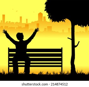 man sitting on the bench and the city in the background