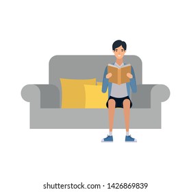 man sitting on chair with book in hands
