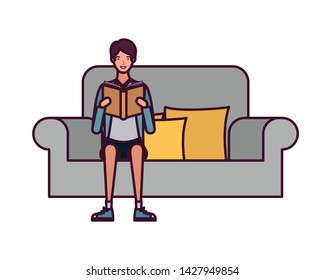 man sitting on chair with book in hands