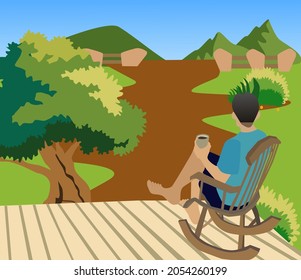 A man sitting on a chair looking at the nature, there are trees, mountains, the atmosphere is very beautiful.