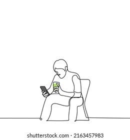 man sitting on a chair with a phone and a cocktail in his hands - one line drawing vector. concept summer holiday, internet addiction, drinking with phone