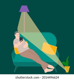 A man sitting on the couch reads the evening news on a tablet. Floor lamp night light - vector. Internet addiction. Doom scroll.
