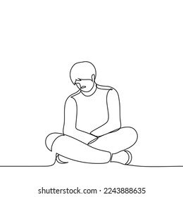 man is sitting on the floor with legs and arms crossed and head down - one line drawing vector. concept sad man sitting in a closed pose