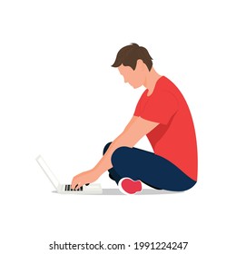 Un hombre sentado en el suelo con una laptop