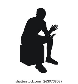 Man sitting on pouf, reading on phone, gesturing with hands, black silhouette