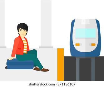 Man sitting on railway platform.