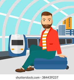 Mann sitzt auf Bahnsteig.