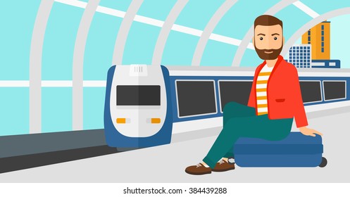 Hombre sentado en la plataforma ferroviaria.