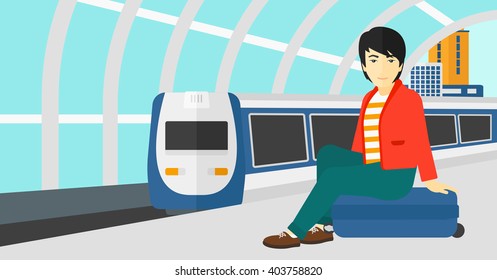 Hombre sentado en la plataforma ferroviaria.