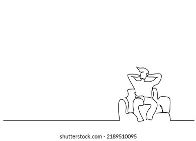 man sitting on sofa calm relax way with hands behind head