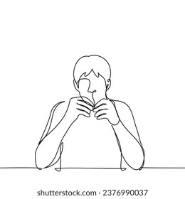 man sitting at the table holding his hands close to his face doing needlework with something very small - one line art vector. concept small parts, fine motor skills activities